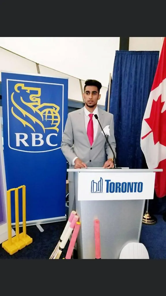 At a podium at a cricket event in Toronto