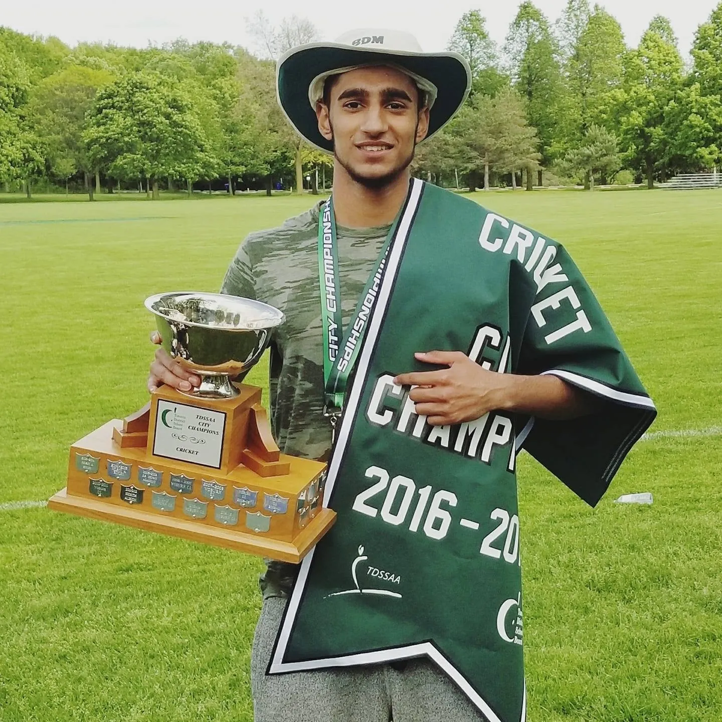 Holding the championship trophy
