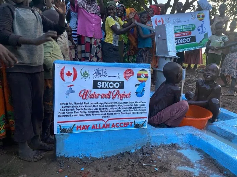 A Sixco borehole water project in Uganda, surrounded by the community it serves