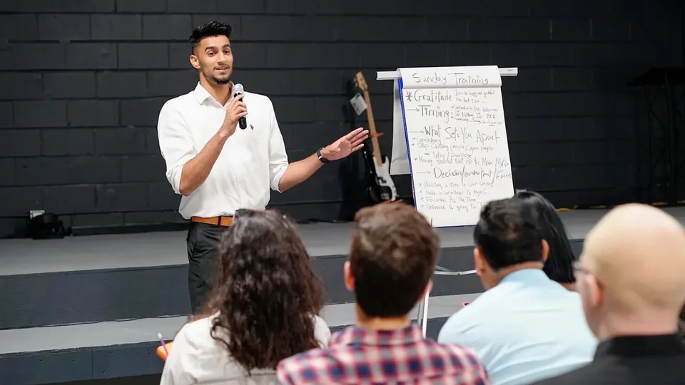 Wasiq speaking to a room during a workshop
